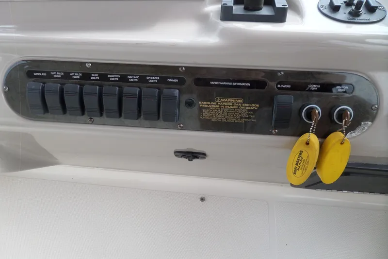 Slide: The Image of Control panel of 2003 Cruisers Yachts 3275 Express with switches and ignition keys. - 23