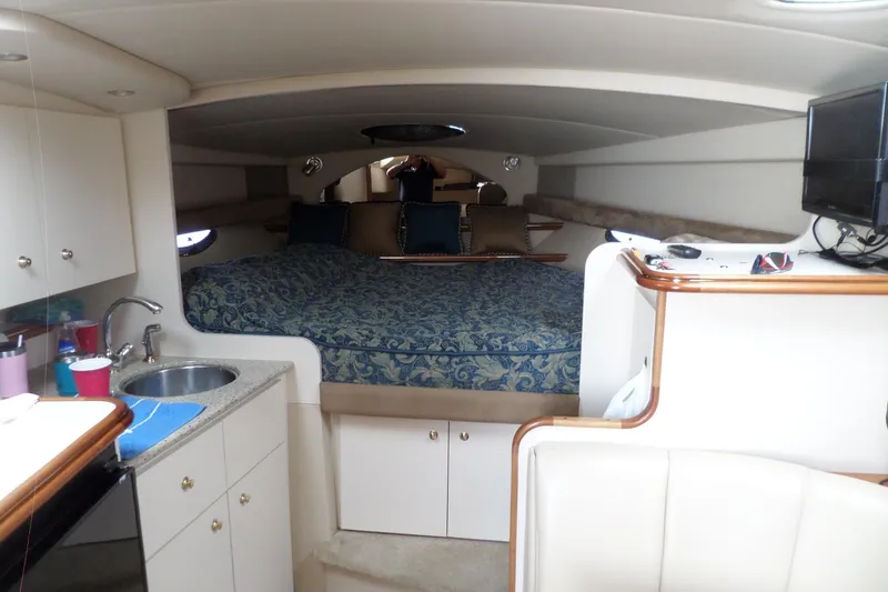 Slide: The Image of Interior of 2003 Cruisers Yachts 3275 Express with bed, kitchenette, and TV. - 31