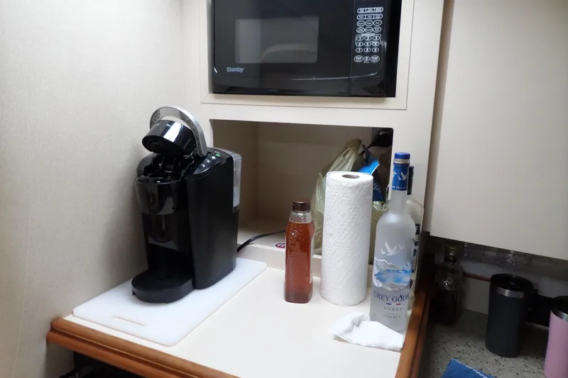 Slide: The Image of Kitchen area in 2003 Cruisers Yachts 3275 Express with coffee maker and microwave. - 36