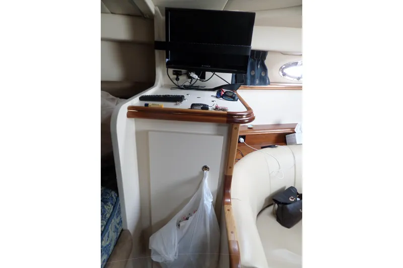 Slide: The Image of 2003 Cruisers Yachts 3275 Express cabin interior with TV and seating area. - 40