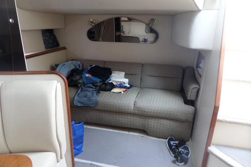Slide: The Image of Interior of 2003 Cruisers Yachts 3275 Express with sofa, clothes, and shoes. - 42