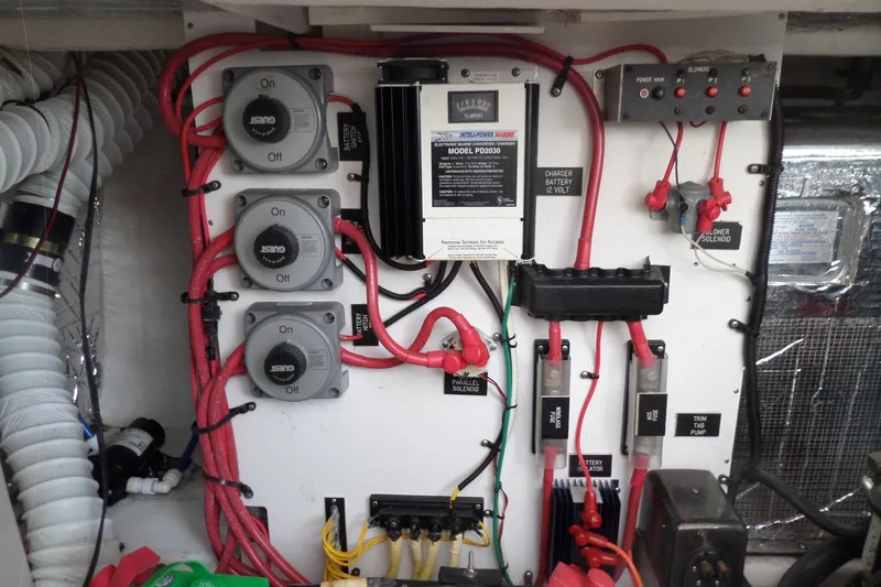 Slide: The Image of Electrical panel of a 2003 Cruisers Yachts 3275 Express with wiring and switches. - 54