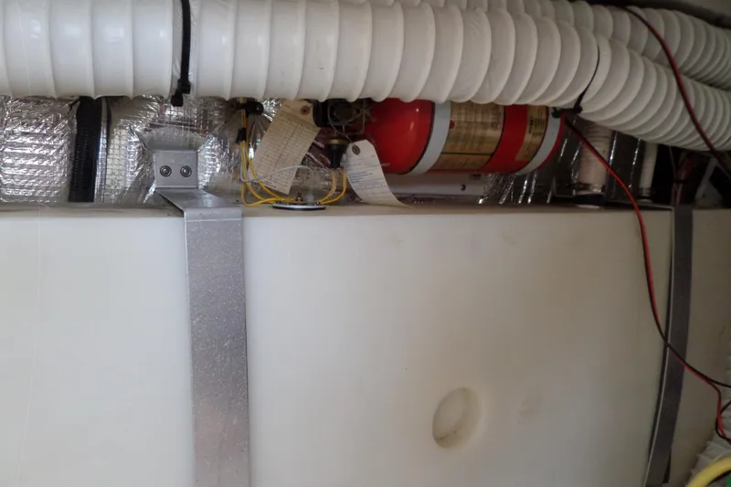 Slide: The Image of Engine compartment of 2003 Cruisers Yachts 3275 Express with fire extinguisher and ventilation ducts. - 60