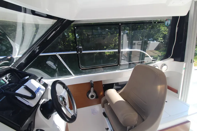 Slide: The Image of 2017 Jeanneau NC Sport 695 boat interior with steering wheel and seating. - 14