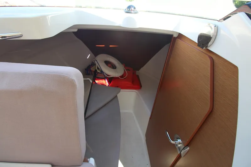Slide: The Image of 2017 Jeanneau NC Sport 695 cabin interior with seating and storage area. - 16