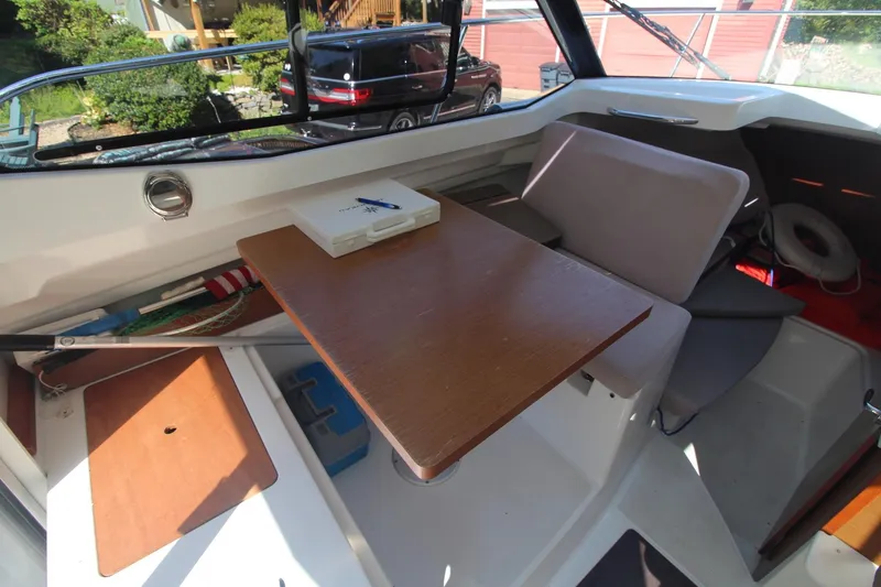 Slide: The Image of Interior of 2017 Jeanneau NC Sport 695 boat with table and seating area. - 17