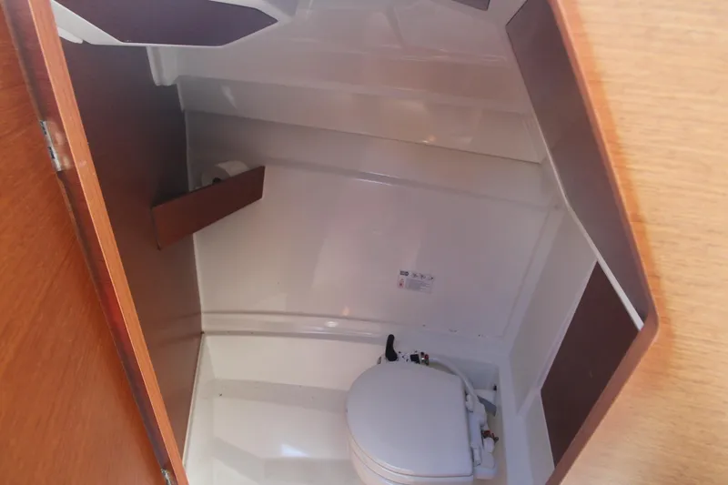 Slide: The Image of 2017 Jeanneau NC Sport 695 boat interior bathroom with compact toilet. - 19