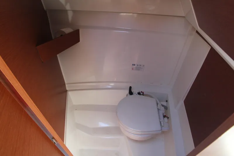 Slide: The Image of 2017 Jeanneau NC Sport 695 boat interior with compact marine toilet. - 21