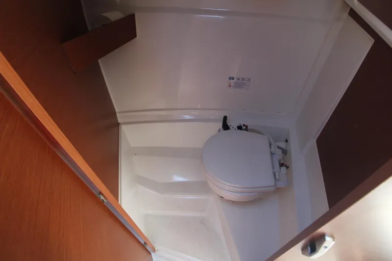 Slide: The Image of 2017 Jeanneau NC Sport 695 boat interior with compact marine toilet. - 22