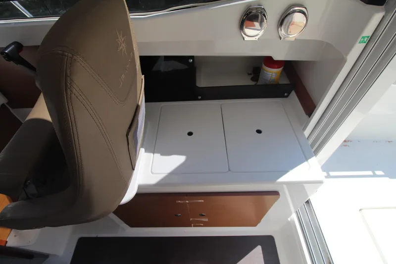Slide: The Image of Interior of 2017 Jeanneau NC Sport 695 boat with seating and storage area. - 23