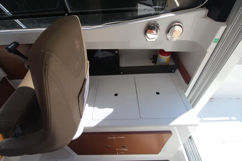 Slide: The Image of Interior of 2017 Jeanneau NC Sport 695 boat, featuring helm seat and control panel. - 24