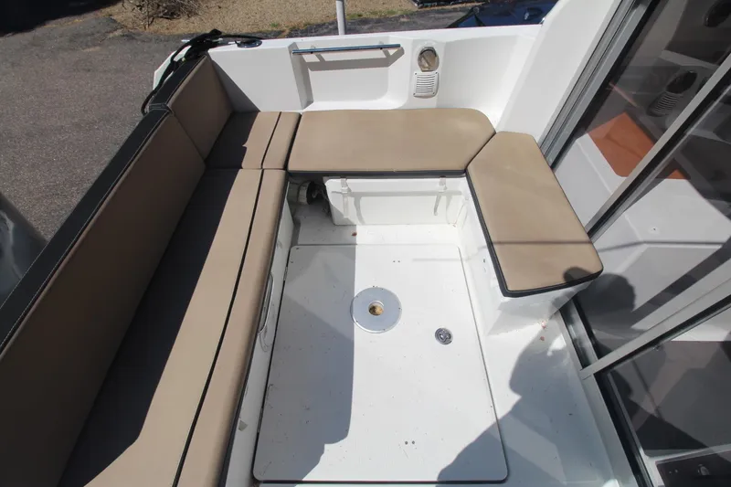 Slide: The Image of 2017 Jeanneau NC Sport 695 boat interior with beige seating and white deck. - 6
