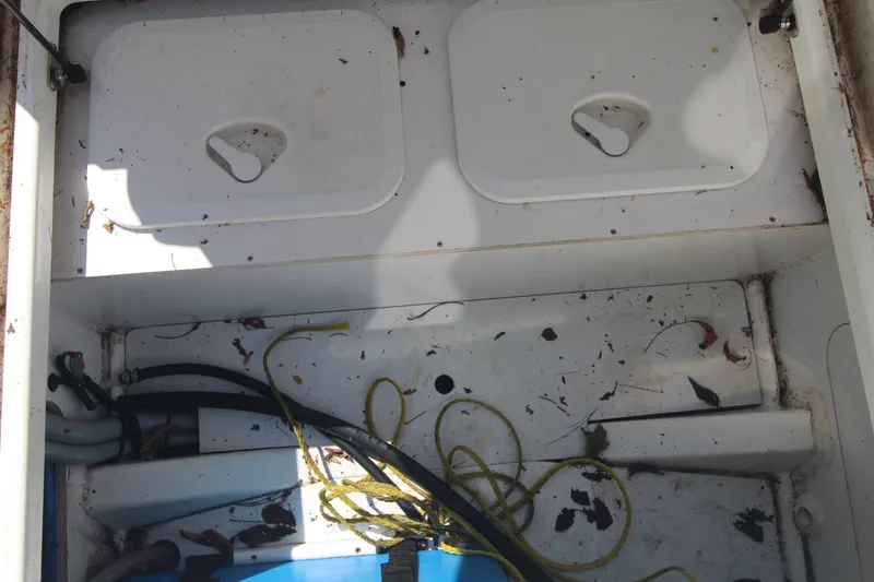 Slide: The Image of Storage compartment of 2017 Jeanneau NC Sport 695 boat, with ropes and debris. - 9