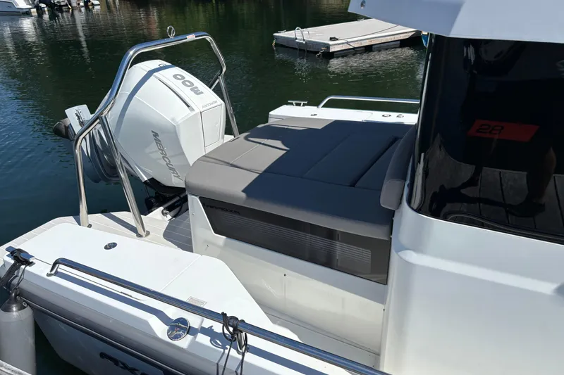 Slide: The Image of 2020 Axopar 28 Cabin Aft Cabin boat with Mercury outboard engine docked on water. - 13