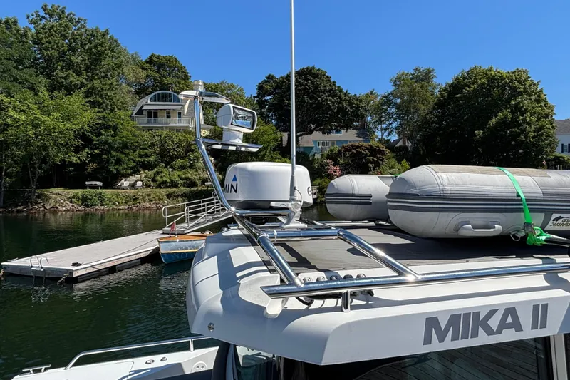 Slide: The Image of 2020 Axopar 28 Cabin Aft Cabin boat docked with inflatable dinghy on deck. - 15