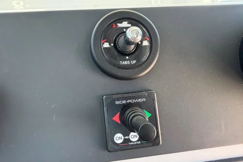 Slide: The Image of Control panel of 2020 Axopar 28 Cabin Aft Cabin boat with trim and thruster switches. - 20