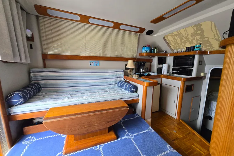 Slide: The Image of Interior of 1992 Luhrs Tournament 320 Convertible with cozy seating and kitchenette. - 10