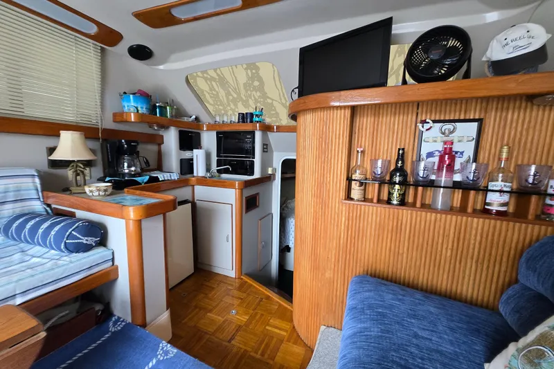 Slide: The Image of Interior of 1992 Luhrs Tournament 320 Convertible boat with cozy seating and kitchenette. - 11