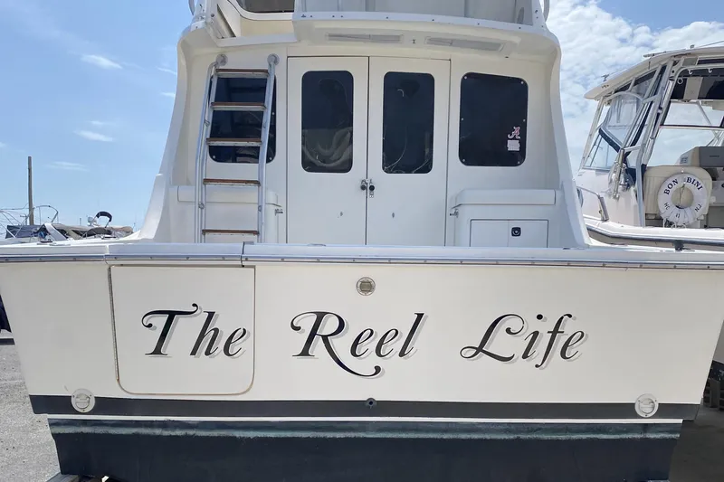 Slide: The Image of 1992 Luhrs Tournament 320 Convertible boat named "The Reel Life" at dock. - 16