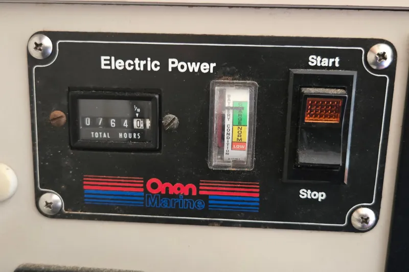 Slide: The Image of Control panel of a 1992 Luhrs Tournament 320 Convertible boat, featuring Onan Marine electric power. - 20