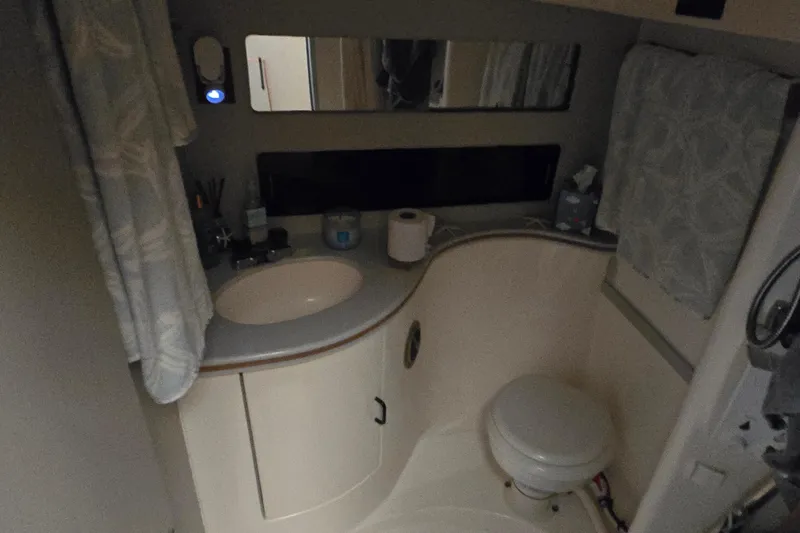 Slide: The Image of Bathroom interior of 1992 Luhrs Tournament 320 Convertible boat, featuring sink and toilet. - 7
