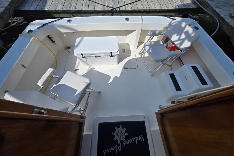 Slide: The Image of 1992 Luhrs Tournament 320 Convertible boat interior with chairs and cooler on deck. - 8