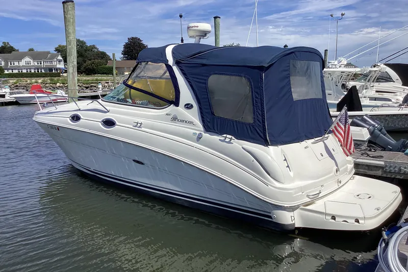 The Image of 2004 Sea Ray 280 Sundancer boat docked in marina with blue canopy. - 0