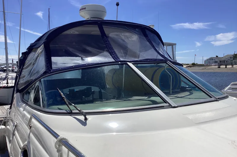 Slide: The Image of 2004 Sea Ray 280 Sundancer docked, featuring a blue canopy and clear windshield. - 5