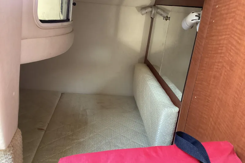 Slide: The Image of 2004 Sea Ray 280 Sundancer cabin interior with bed and mirror. - 8