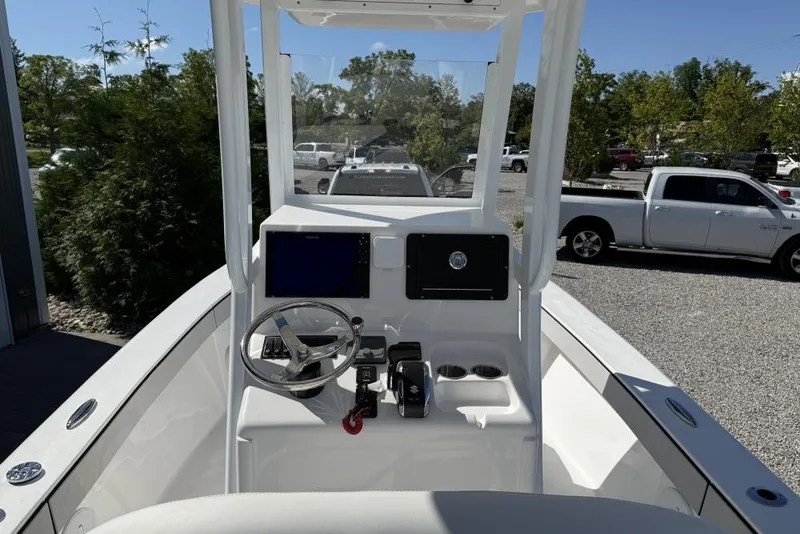 Slide: The Image of Center console of a 2026 Delta D245 boat with steering wheel and controls. - 3