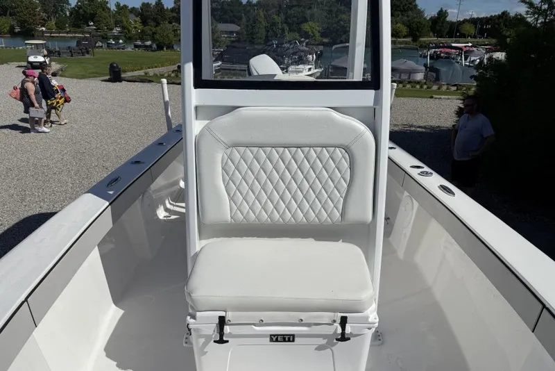 Slide: The Image of White Delta D245 boat seat with diamond pattern, 2026 model, parked near marina. - 4
