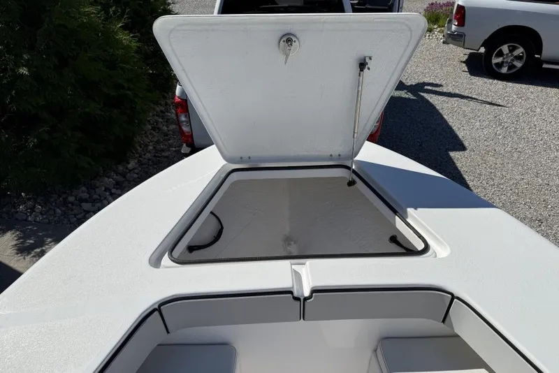 Slide: The Image of Open storage compartment on a 2026 Delta D245 boat, parked on gravel. - 6