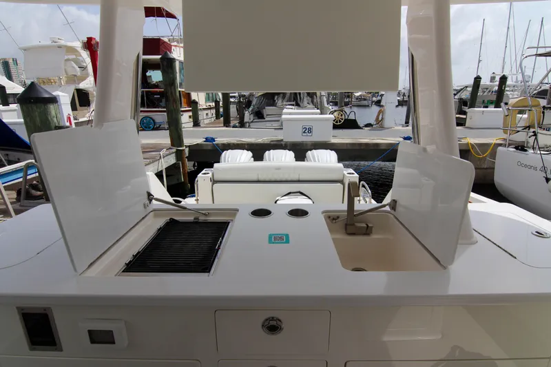 Slide: The Image of 2023 Regal 38 SAV boat with outdoor kitchen and sink at marina. - 13