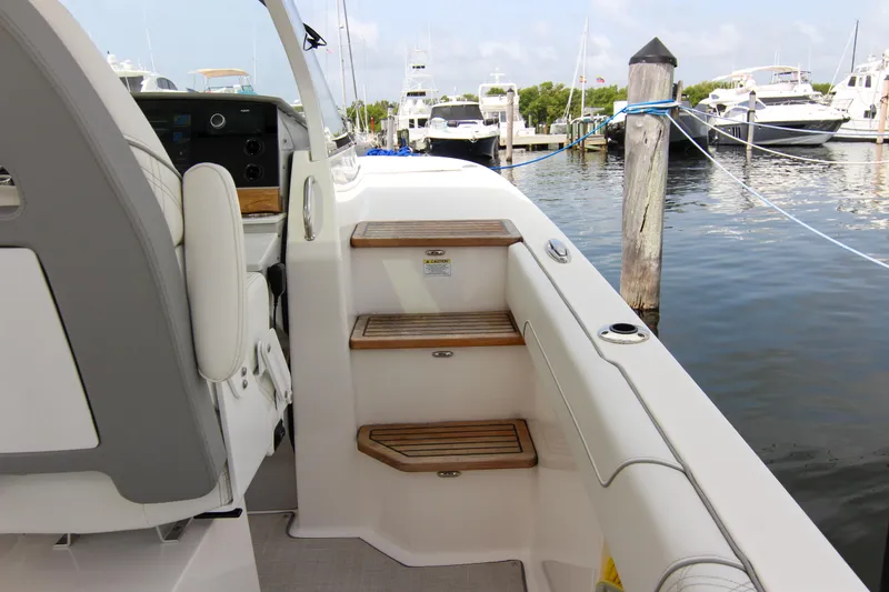 Slide: The Image of 2023 Regal 38 SAV boat interior with wooden steps at marina. - 15