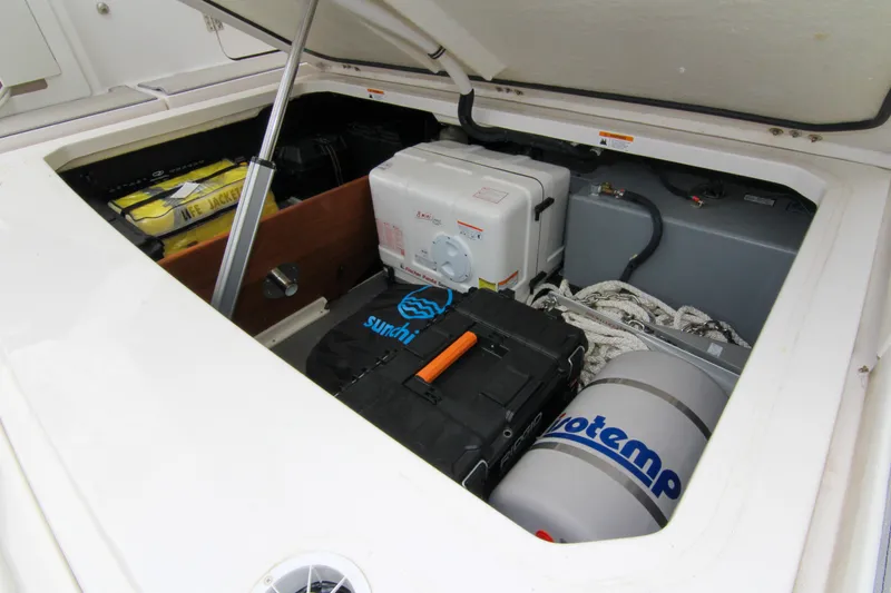 Slide: The Image of Open storage compartment of 2023 Regal 38 SAV boat with equipment and supplies. - 21