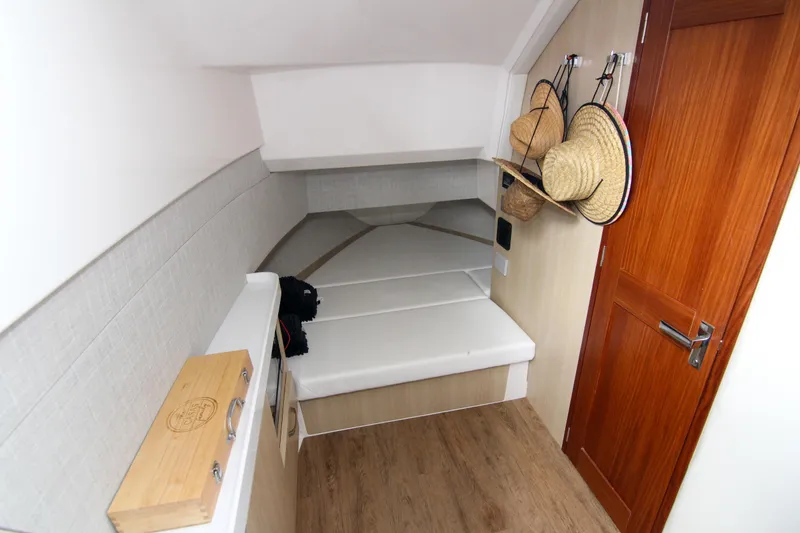 Slide: The Image of 2023 Regal 38 SAV cabin interior with wooden flooring and wall hooks. - 28