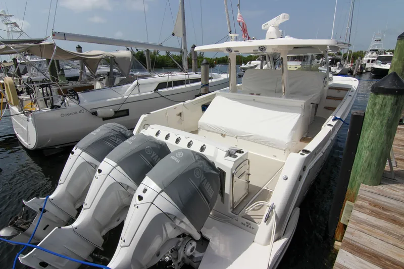 Slide: The Image of 2023 Regal 38 SAV boat docked with triple Yamaha outboard engines. - 31
