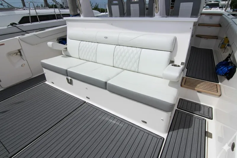 Slide: The Image of 2023 Regal 38 SAV boat interior with white cushioned seating and sleek flooring. - 33