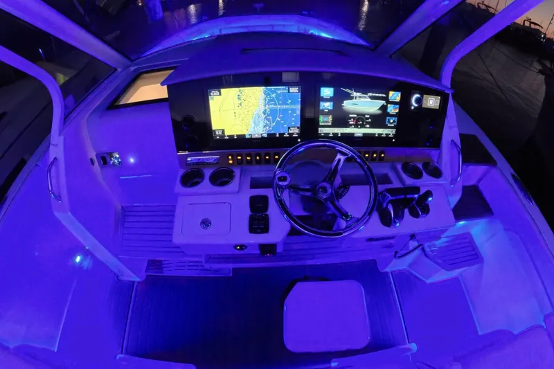 Slide: The Image of 2023 Regal 38 SAV boat cockpit with illuminated controls and navigation screens. - 39