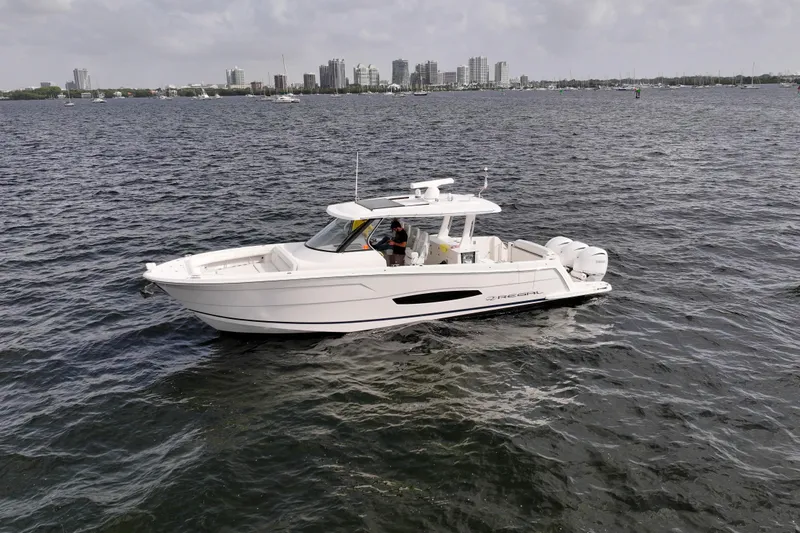 Slide: The Image of 2023 Regal 38 SAV boat cruising on a city waterfront. - 4