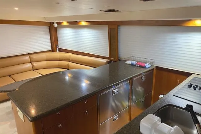 Slide: The Image of Luxurious interior of 1989 Buddy Davis 61 Sportfish yacht with modern kitchen and seating area. - 13