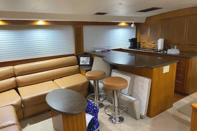 Slide: The Image of Luxurious interior of a 1989 Buddy Davis 61 Sportfish yacht with leather seating and modern kitchen. - 14