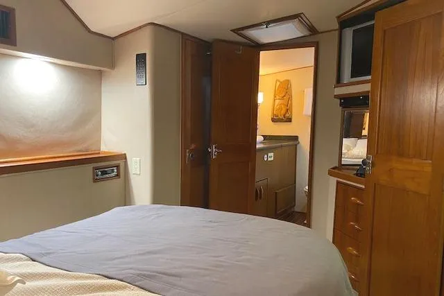 Slide: The Image of Cozy cabin interior of 1989 Buddy Davis 61 Sportfish yacht with wooden furnishings. - 16