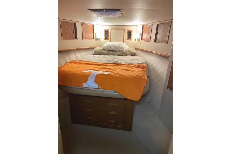 Slide: The Image of Cozy cabin interior of 1989 Buddy Davis 61 Sportfish with bed and orange blanket. - 27