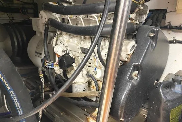 Slide: The Image of Engine room of a 1989 Buddy Davis 61 Sportfish boat, showcasing mechanical components. - 31