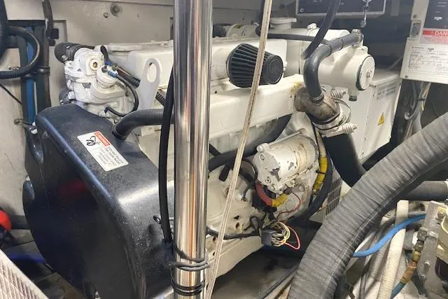 Slide: The Image of Engine room of 1989 Buddy Davis 61 Sportfish boat, showcasing mechanical components and wiring. - 32