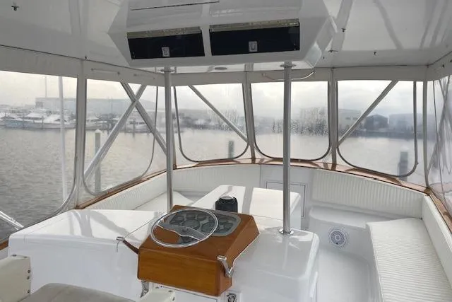 Slide: The Image of 1989 Buddy Davis 61 Sportfish boat interior with helm, overlooking marina. - 34