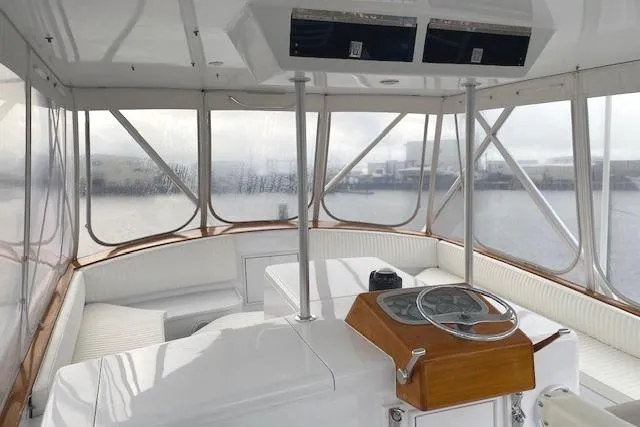 Slide: The Image of 1989 Buddy Davis 61 Sportfish helm with panoramic windows and classic wooden accents. - 35