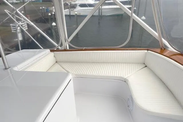 Slide: The Image of 1989 Buddy Davis 61 Sportfish yacht with white cushioned seating area. - 39