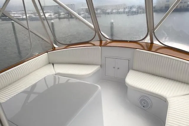 Slide: The Image of 1989 Buddy Davis 61 Sportfish yacht interior with white seating and panoramic windows. - 41